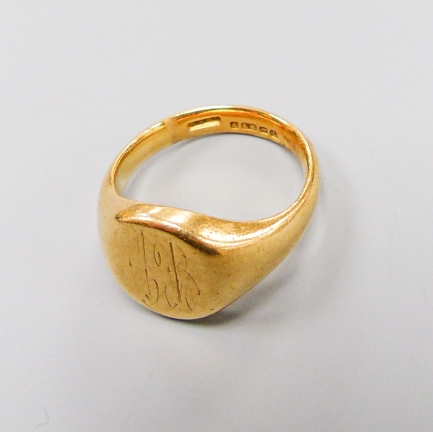 A 1950's 19ct gold signet ring, with engraved inscription, size M, 14.3 grams.